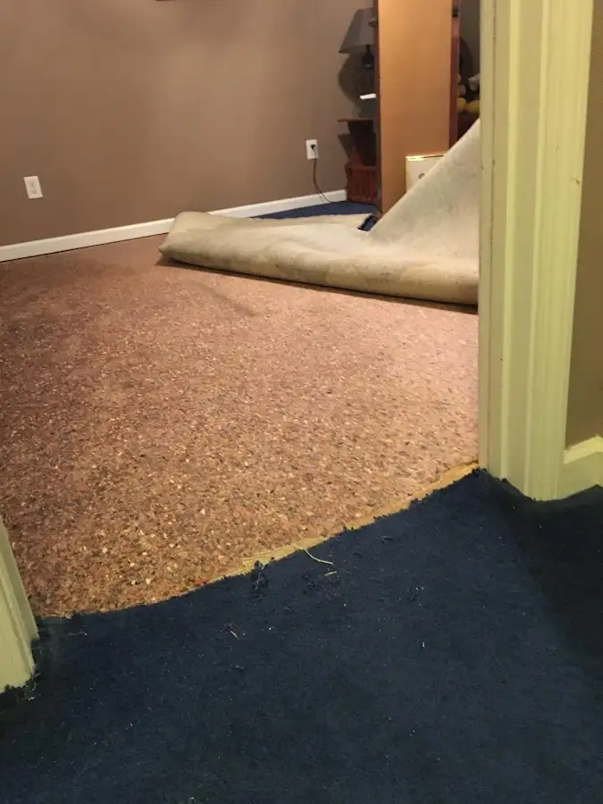 Carpet pad removal revealing water damage during Water Mitigation Services in Skowhegan